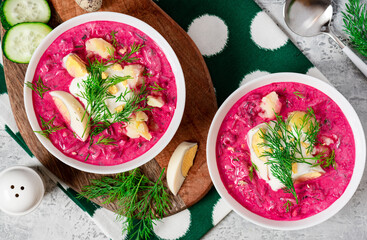 Chłodnik (Šaltibarščiai) - traditional east european soup. Cold summer soup of beets, kefir, cucumbers, eggs and dill in a white bowl top view. Summer food, Eastern European cuisine.