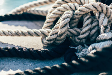 Fototapeta premium Vintage old sea rope near the port, summer time