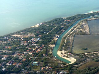 Medium wide aerial view of Nassau, Bahamas coastal areas seen from an airplane window.