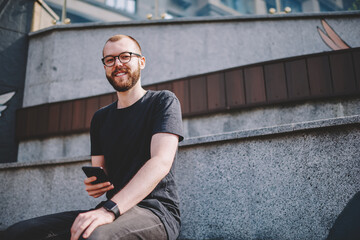 Positive hipster blogger calling on telephone device