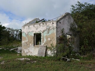 Remnants of a dilapidated structure abandoned by its owners after a typhoon in a tropical island