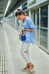Fototapeta na wymiar young woman with handbag in subway station