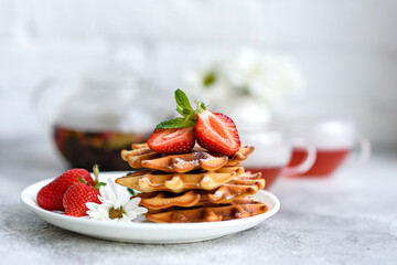 Delicious fresh baked belgian waffles with berries and fruit
