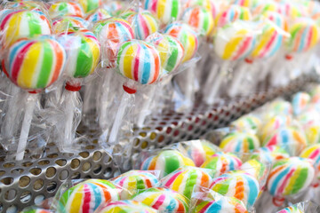 Fototapeta na wymiar Lots of delicious colorful candy lollipops on the shelf .