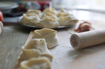 Fototapeta na wymiar Handmade dumplings process in the kitchen