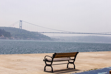 Fototapeta na wymiar empty wooden benches by the seaside. Istanbul Bosporus. Empty streets of Istanbul from Lock down. Quarantine days in Turkey