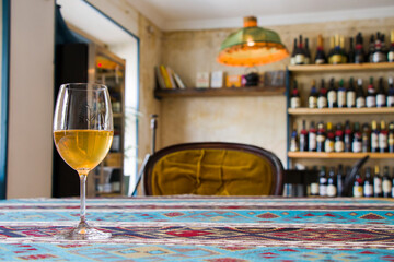 Full wineglass with white wine on the table in the restaurant, cafe and bar. White wine in wineglass.