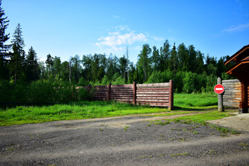 fence in the forest with a sign prohibiting entry