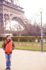 man in sunglasses, tourist with video camera walks in spring Paris.