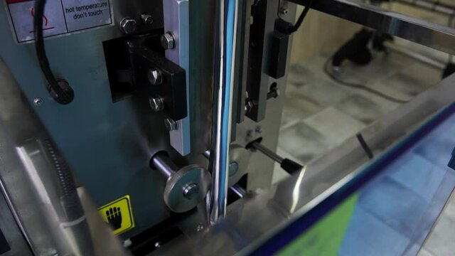 The working process of the technical device for automatic packaging of food sachets for packing food at a large enterprise. Close-up