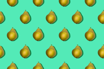 Bright seamless photo pattern of yellow pear on green background top view