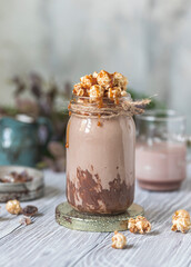 Chocolate milkshake with caramel popcorn. Selective focus