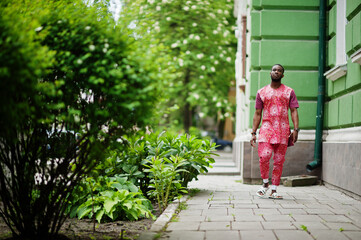 Fototapeta na wymiar Portrait of a black young man wearing african traditional red colorful clothes.