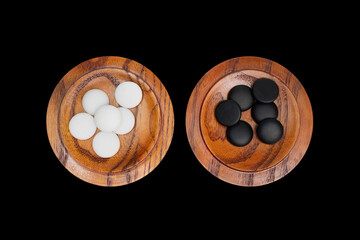 weiqi or baduk game board - captivated stones on bowl covers - clipping path