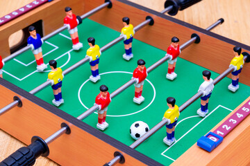 Close up table soccer with players and a ball.