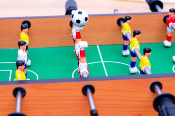 Close up table soccer with players and a ball.