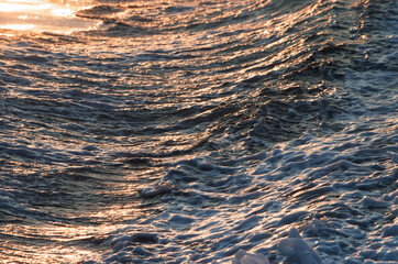 The magic sea surface in the glow of the setting sun