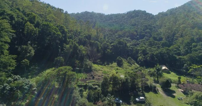 Aerial drone view of small contryside house dense forest in countryside mountains. Serra da Cantareira Brazil. Rural Countryside lifestyle concept
