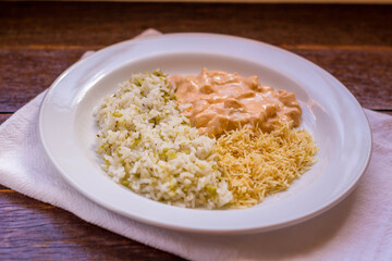 Delicious healthy food with chicken strogonoff with rice and french fries on dish. View from the top