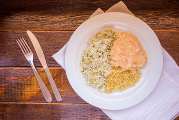 Delicious healthy food with chicken strogonoff with rice and french fries on dish. View from the top