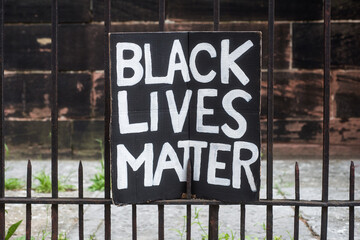 Closeup of black lives matter slogan on cardboard in the street