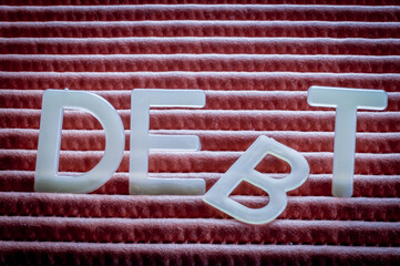 Drop Debt, word written with letters on a striped background, the third letter fell. Concept about...
