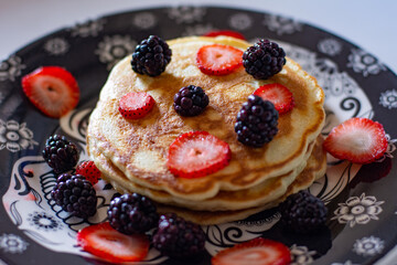 Delicious pancakes with blackberries and strawberries