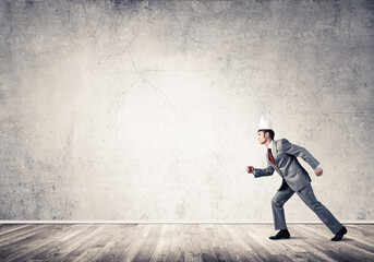 King businessman in elegant suit running in empty room