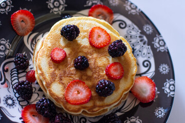 Delicious pancakes with blackberries and strawberries