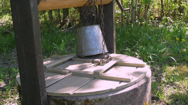 A wooden cover on the deep old well in the village in Estonia