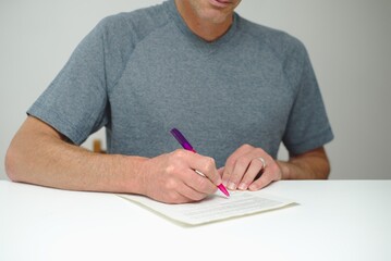 Man adding signature to document