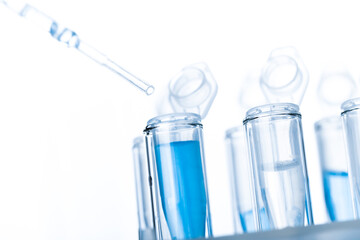 microbiological pipette in the genetic laboratory. study of a virus or vaccination. blue tinted.