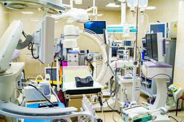 Clinic interior with operating surgery table, lamps and ultra modern devices, technology, hi-tech interior. Robotic equipment.