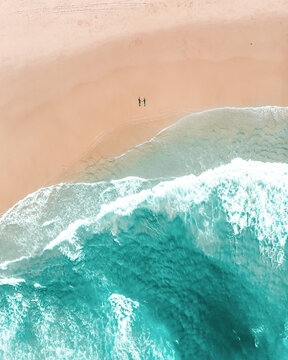 Aerial view of Tallebudgera Beach with a couple holding hands forming a silhouette with their shadows, Gold Coast, Australia