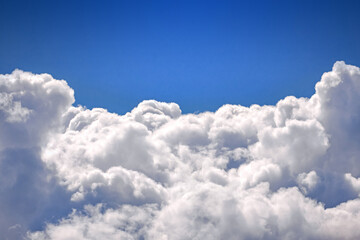 Naklejka na ściany i meble Beautiful blue sky and white fluffy clouds, view sky from an airplane