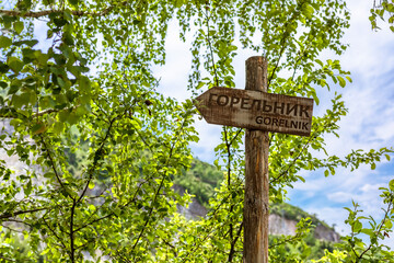 wooden sign in the mountains, the text 