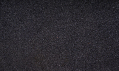 Closeup shot of black foam rubber. Thin sheet of black foam rubber texture - obrazy, fototapety, plakaty