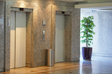Two elevator doors in office building. Wide angle view of modern elevators with doors. Elevators in the modern lobby house or hotel.