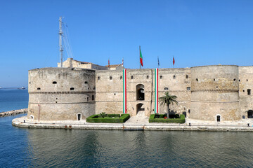 View of the Aragonese Castle with Italian flags to celebrate April 25, Italy's Liberation Day -...