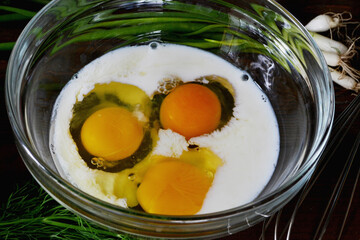 3 egg omelet with milk. Cook breakfast. Eggs with milk in a glass plate