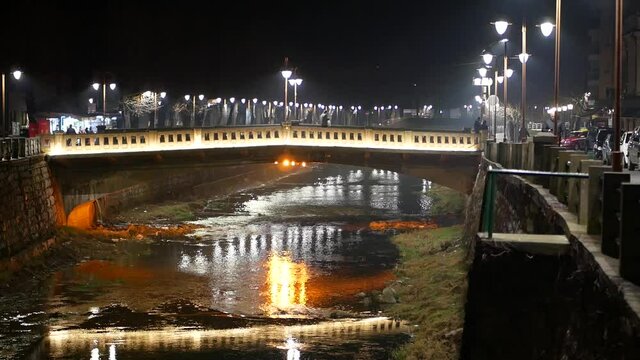 Concrete river bridge, night cityscape