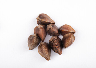 seven buckweat seeds in a peel on white background