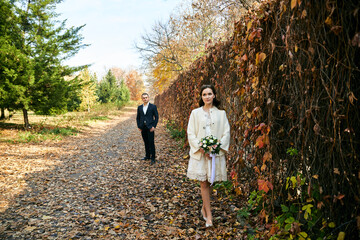 Fototapeta premium Young male and woman just married. Concept of happy family. Modern family outdoor.