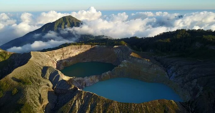Amazing Kelimutu volcano and its tri-colored lakes, aerial view with mountains, volcano and cloud in Flores, Indonesia