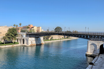 Fototapeta premium Overview of the Bridge of San Francesco di Paola, commonly called Ponte Girevole (Swing Bridge) and the waterway in Taranto, Puglia, Italy