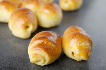 sausage in the dough homemade pastries, rich bagels stuffed with on a dark background