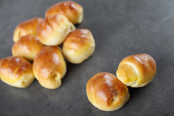 sausage in the dough homemade pastries, rich bagels stuffed with on a dark background