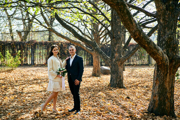 Fototapeta premium Young male and woman just married. Concept of happy family. Modern family outdoor.