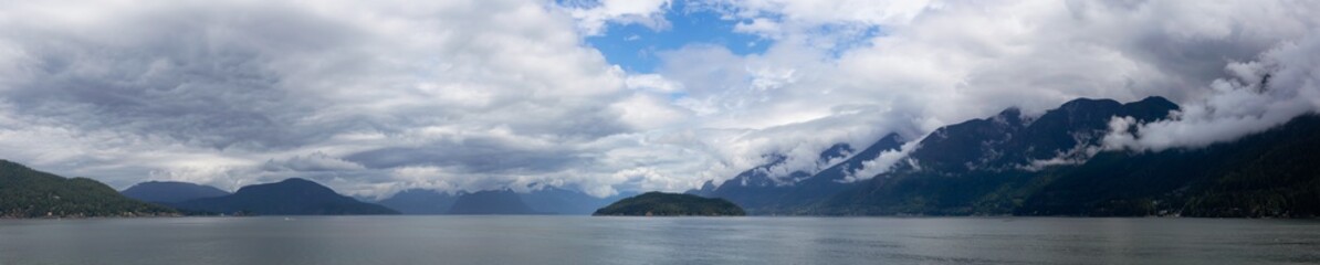 Fototapeta na wymiar Beautiful Panoramic Canadian Landscape view of Howe Sound during a cloudy and sunny day. Taken near West Vancouver, British Columbia, Canada. Nature Background Panorama