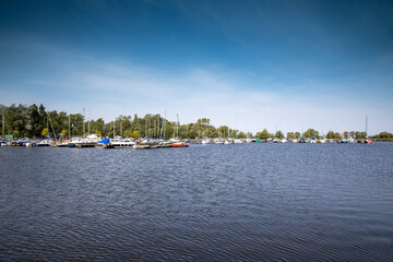 Fototapeta premium View of boats moored at Kinnego marina , Lough Neagh, near Lurgan, Northern Ireland on a warm sunny spring day